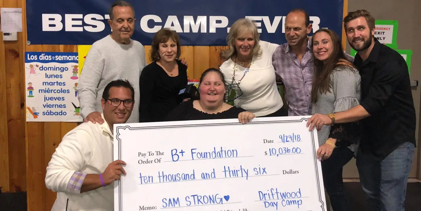 Driftwood presents a $10,036 check to the B+ Foundation